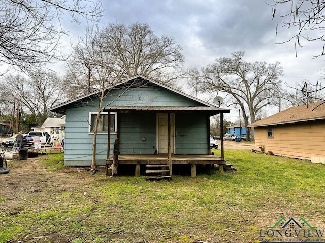 back of property featuring a yard