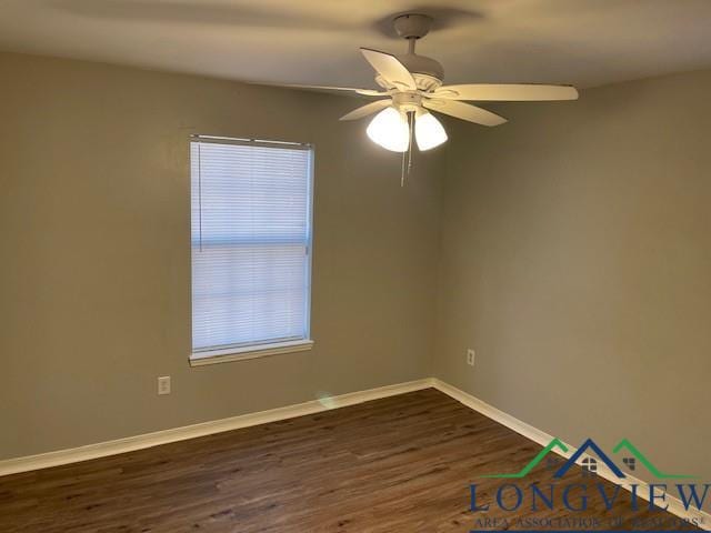 empty room featuring ceiling fan and dark wood-type flooring