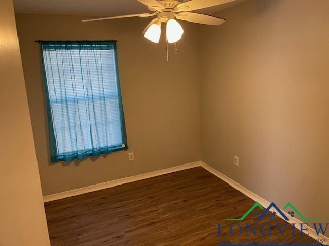 spare room with ceiling fan and dark hardwood / wood-style flooring