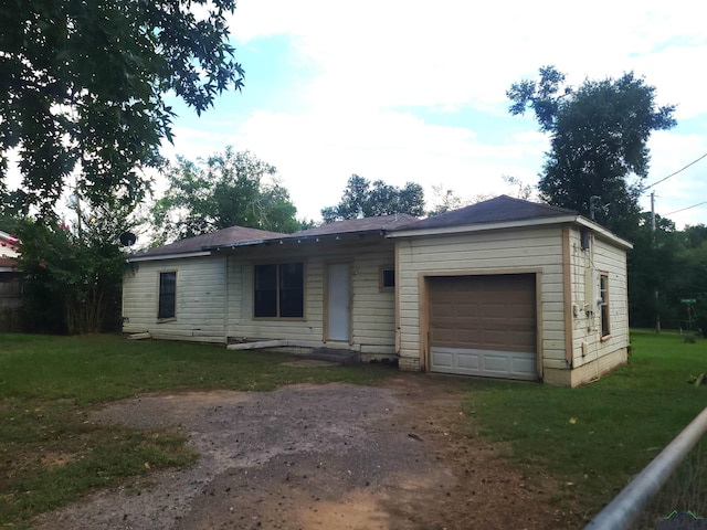 ranch-style home with a garage and a front yard