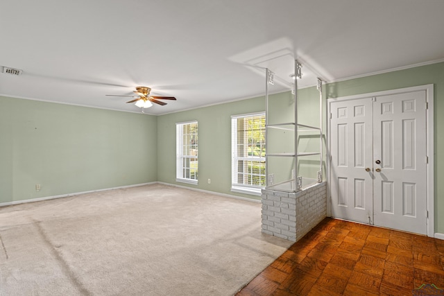 unfurnished living room with carpet floors, ceiling fan, and ornamental molding