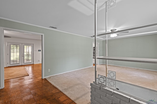 interior space with ceiling fan, french doors, and ornamental molding