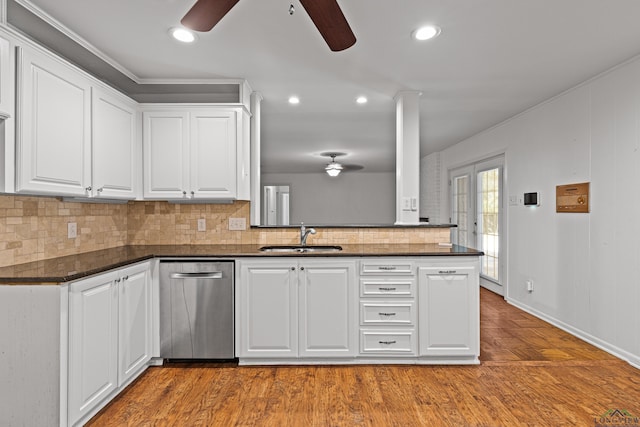 kitchen featuring dishwasher, french doors, sink, kitchen peninsula, and white cabinetry