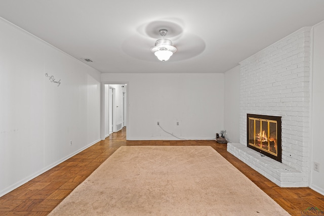 unfurnished living room featuring ceiling fan, parquet floors, and a fireplace