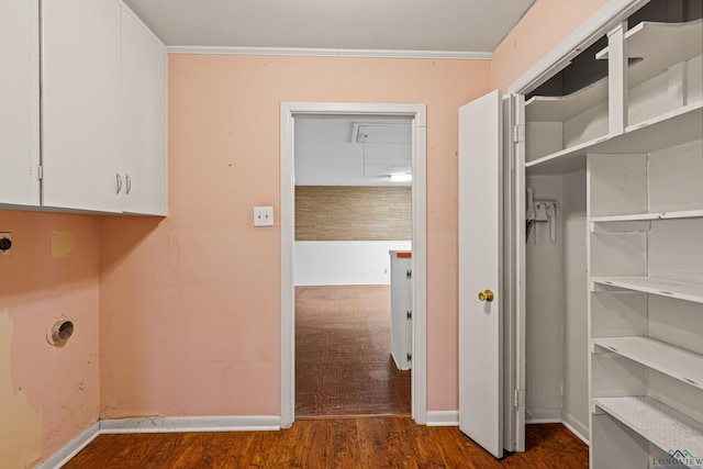 washroom featuring hookup for an electric dryer, dark hardwood / wood-style floors, cabinets, and ornamental molding