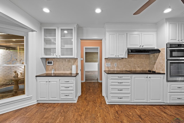 kitchen with decorative backsplash, dark hardwood / wood-style flooring, and white cabinets