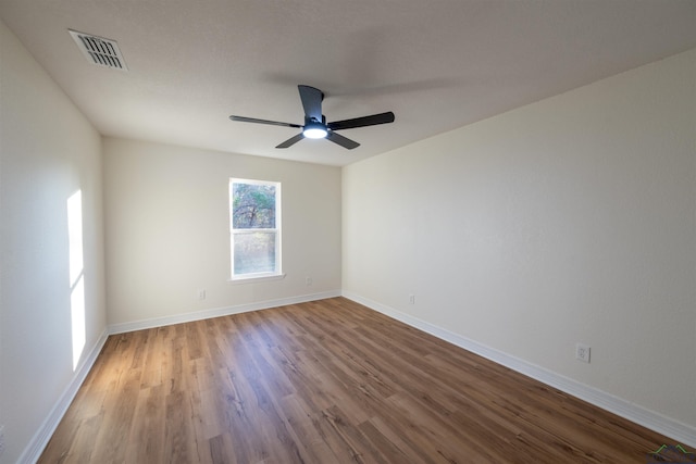 empty room with hardwood / wood-style flooring and ceiling fan