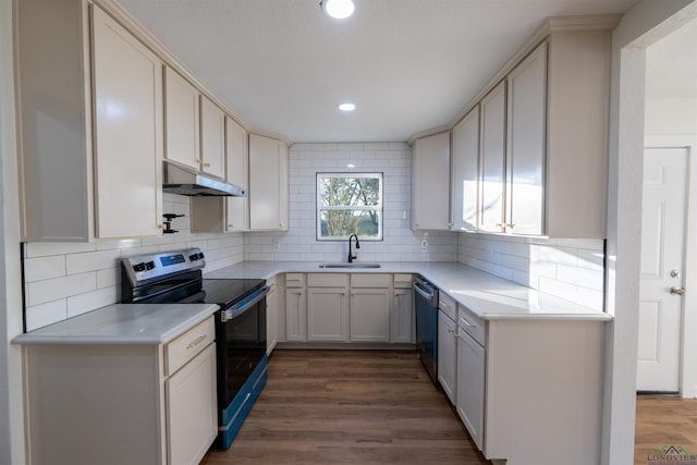 kitchen featuring decorative backsplash, sink, stainless steel appliances, and dark hardwood / wood-style floors