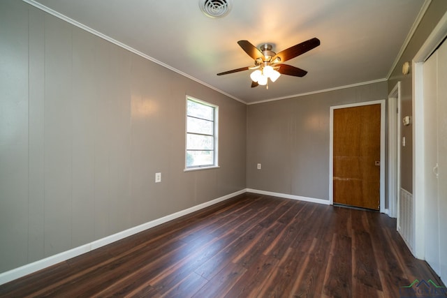 unfurnished room with crown molding, ceiling fan, and dark hardwood / wood-style floors