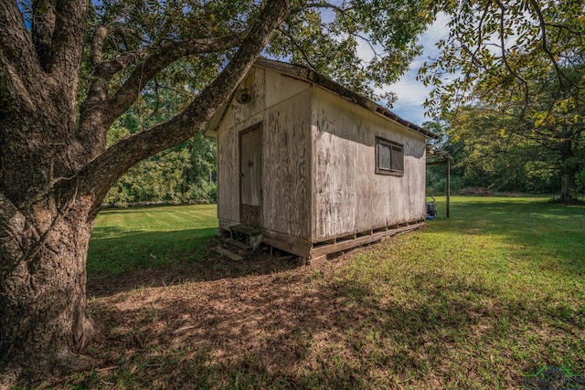 view of outbuilding featuring a yard