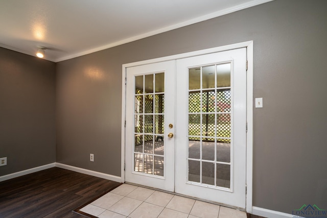 doorway with light hardwood / wood-style floors, crown molding, and french doors