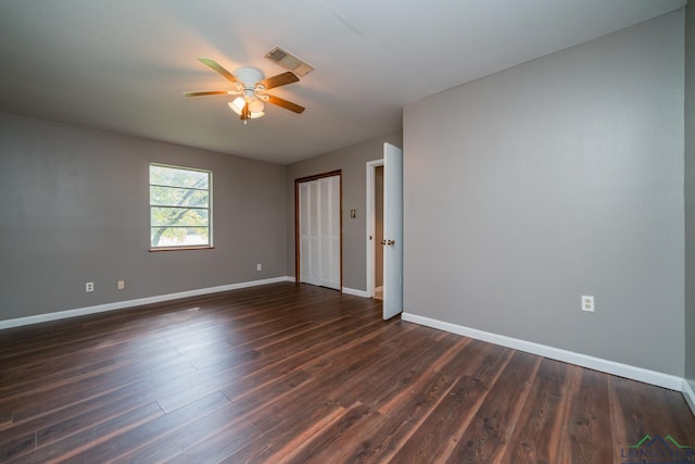 spare room with ceiling fan and dark hardwood / wood-style flooring