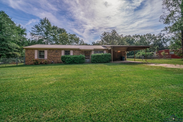 ranch-style home with a front yard and a carport