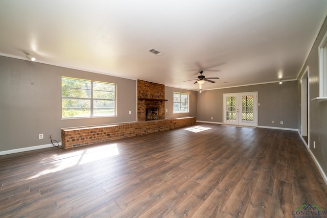 unfurnished living room with dark hardwood / wood-style floors, ceiling fan, plenty of natural light, and a fireplace