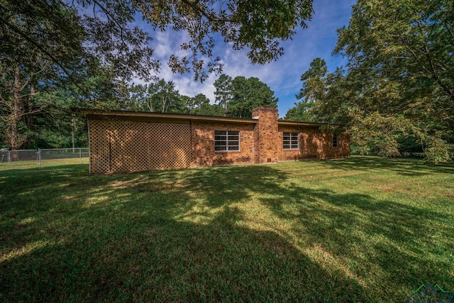 back of house with a yard