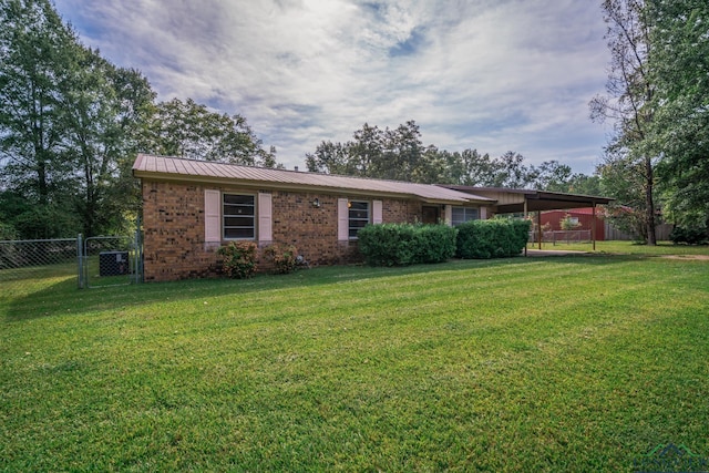 single story home with a front lawn and a carport