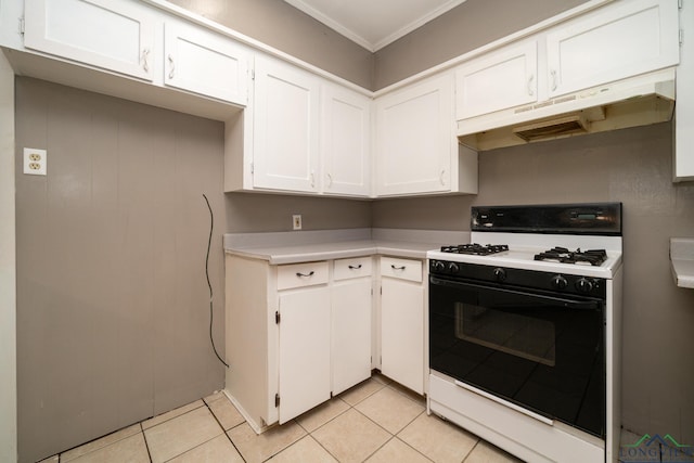 kitchen with white cabinets, white gas stove, light tile patterned flooring, and crown molding