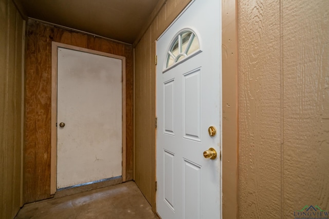 doorway featuring wood walls