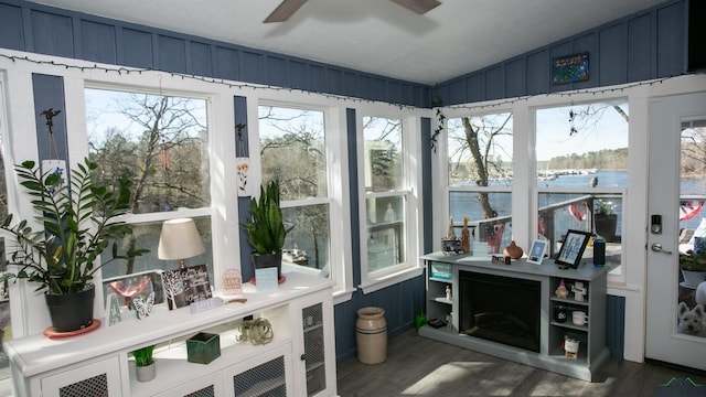 sunroom with vaulted ceiling and wood finished floors