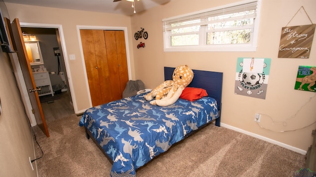 carpeted bedroom with baseboards and a closet