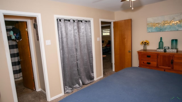 carpeted bedroom with baseboards and ceiling fan