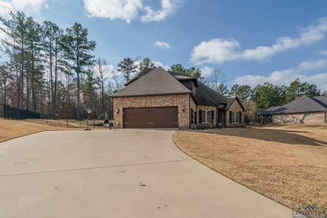 view of front of home with a garage and a front yard