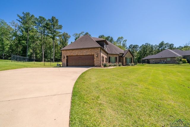 view of front of home with a front yard and a garage