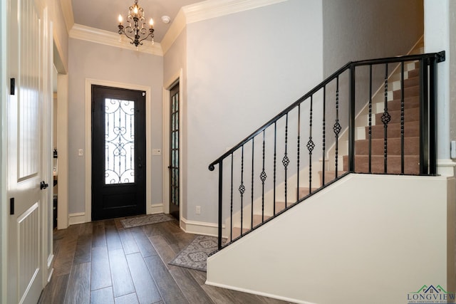 entrance foyer featuring a notable chandelier, dark hardwood / wood-style flooring, and ornamental molding