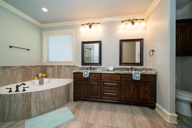 bathroom featuring tiled bath, crown molding, vanity, and toilet