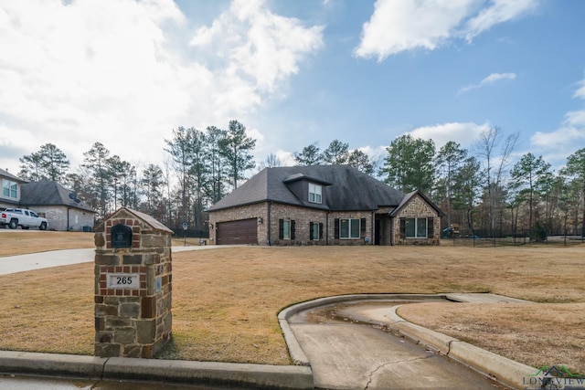 view of front of property with a front lawn and a garage