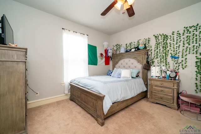 bedroom with ceiling fan and light carpet