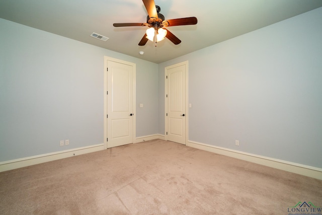 carpeted spare room featuring ceiling fan