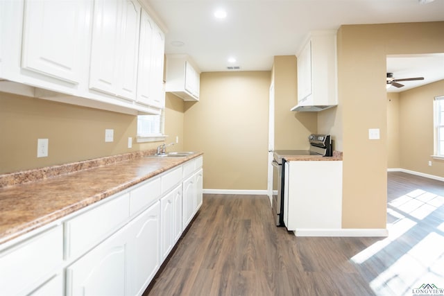 kitchen featuring electric stove, white cabinetry, dark hardwood / wood-style flooring, and sink