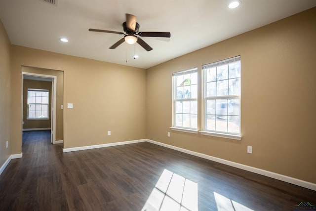 empty room with ceiling fan and dark hardwood / wood-style flooring