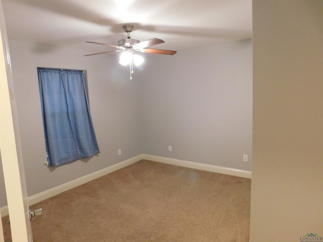 spare room with ceiling fan and carpet