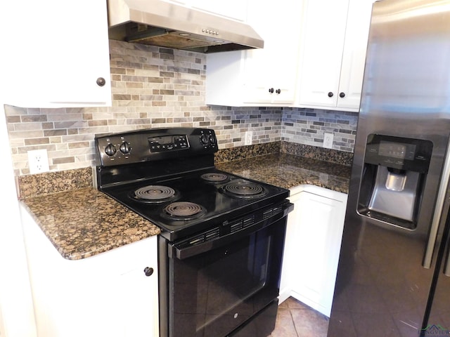 kitchen with black electric range, stainless steel fridge, white cabinetry, and range hood