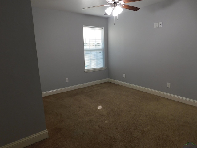 empty room with dark colored carpet and ceiling fan