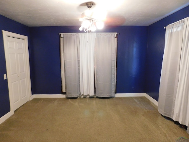 unfurnished bedroom featuring carpet flooring and a textured ceiling