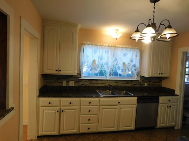 kitchen with tasteful backsplash, stainless steel dishwasher, sink, pendant lighting, and white cabinets