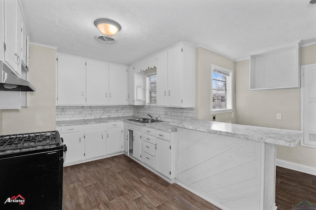 kitchen featuring sink, black gas range oven, dark hardwood / wood-style flooring, plenty of natural light, and white cabinets