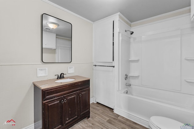 full bathroom with vanity, crown molding, shower / bathing tub combination, and wood-type flooring