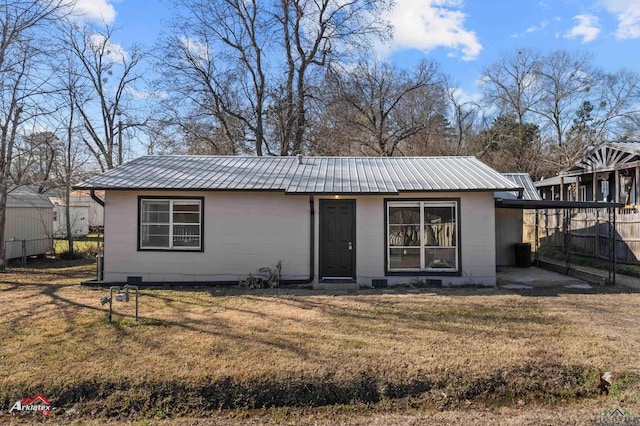 rear view of property with a lawn