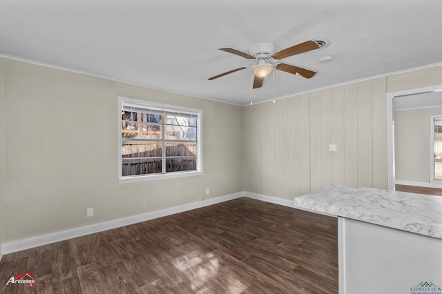 unfurnished room featuring ceiling fan, ornamental molding, and dark wood-type flooring