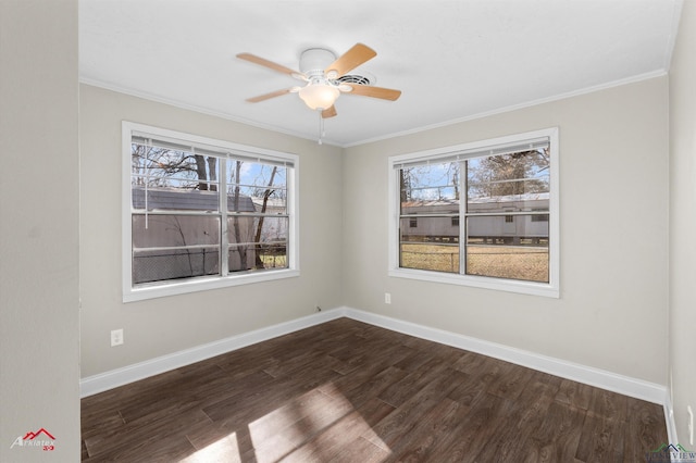 empty room with dark hardwood / wood-style floors, ornamental molding, and a wealth of natural light