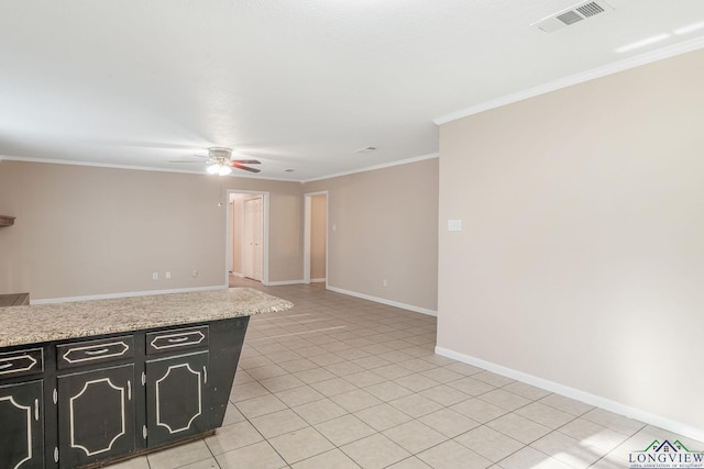 kitchen featuring light stone counters, ceiling fan, light tile patterned floors, and crown molding