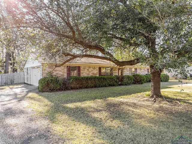 single story home with a front yard and a garage