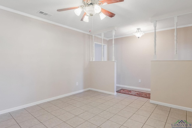 spare room featuring light tile patterned floors, ceiling fan, and crown molding