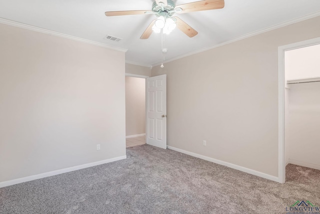 unfurnished bedroom featuring ceiling fan, light colored carpet, ornamental molding, and a closet