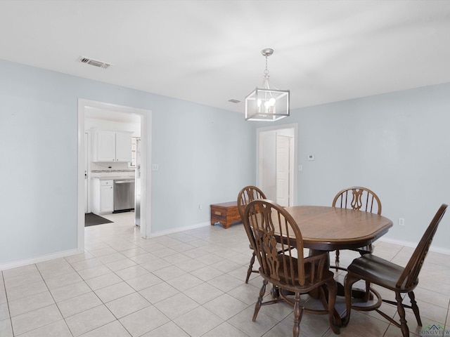 tiled dining area featuring a chandelier