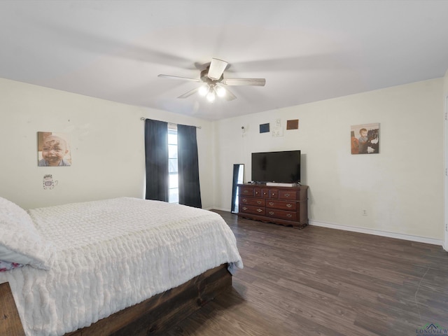 bedroom with ceiling fan and dark hardwood / wood-style flooring